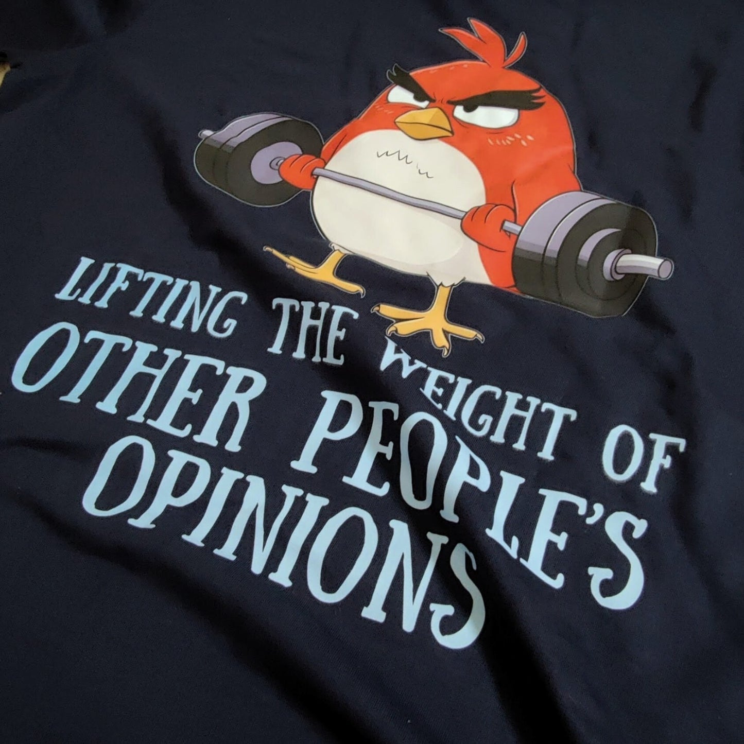 Back-printed funny t-shirt featuring cartoon bird lifting weights illustration