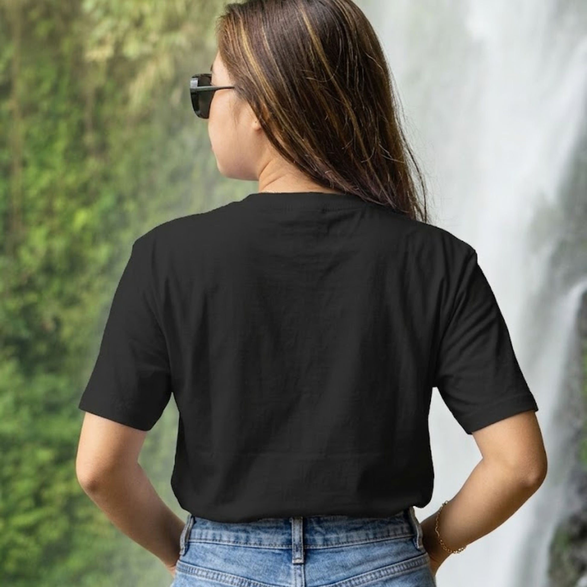 Back side of a black cotton T-shirt displaying a coffee quote and cat graphic on the front.