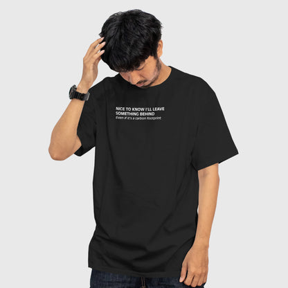Front view of a black oversized T-shirt with a dry, understated carbon footprint joke