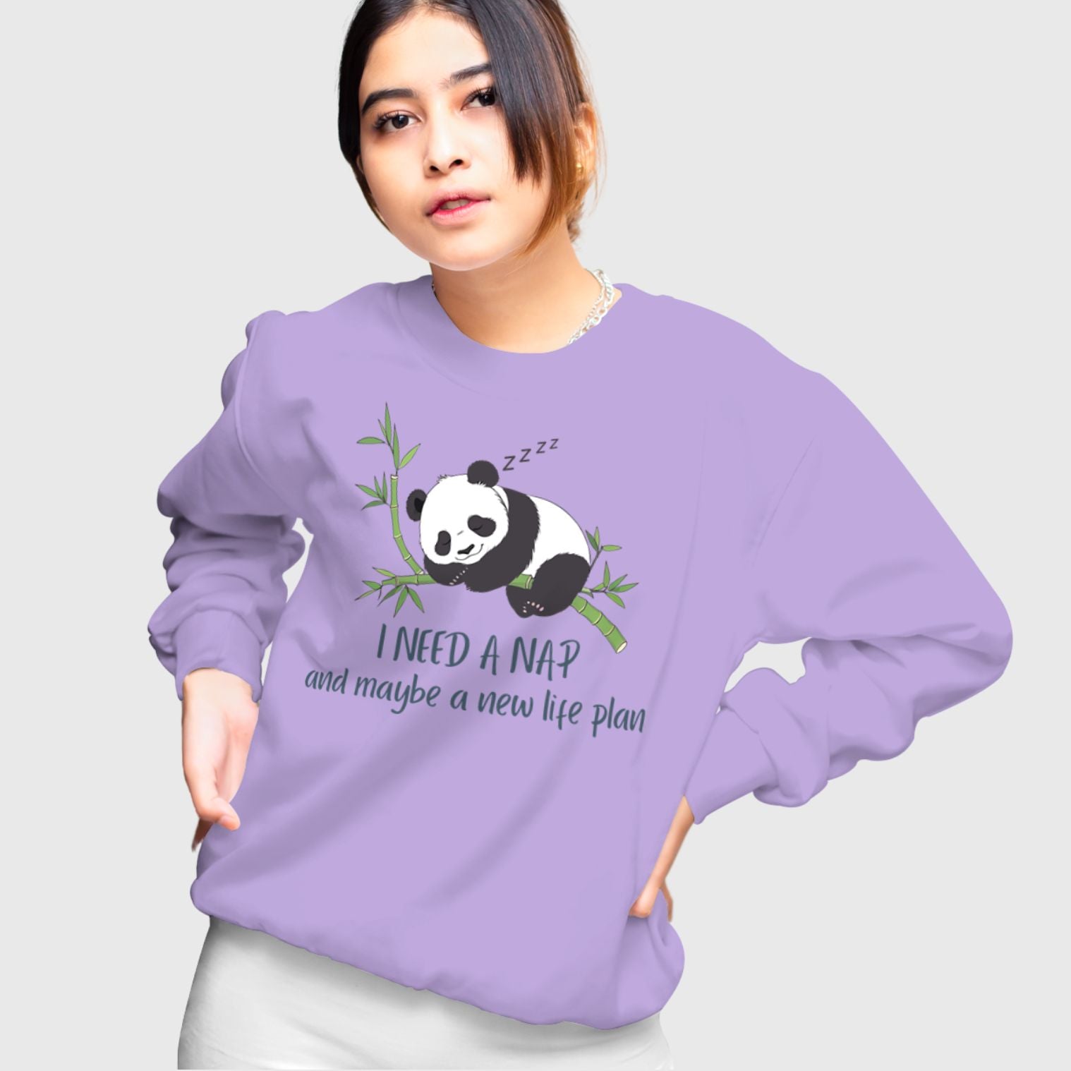 Model wearing “I Need a Nap & a Life Plan” funny relatable unisex sweatshirt by The Grumpy Ninja.