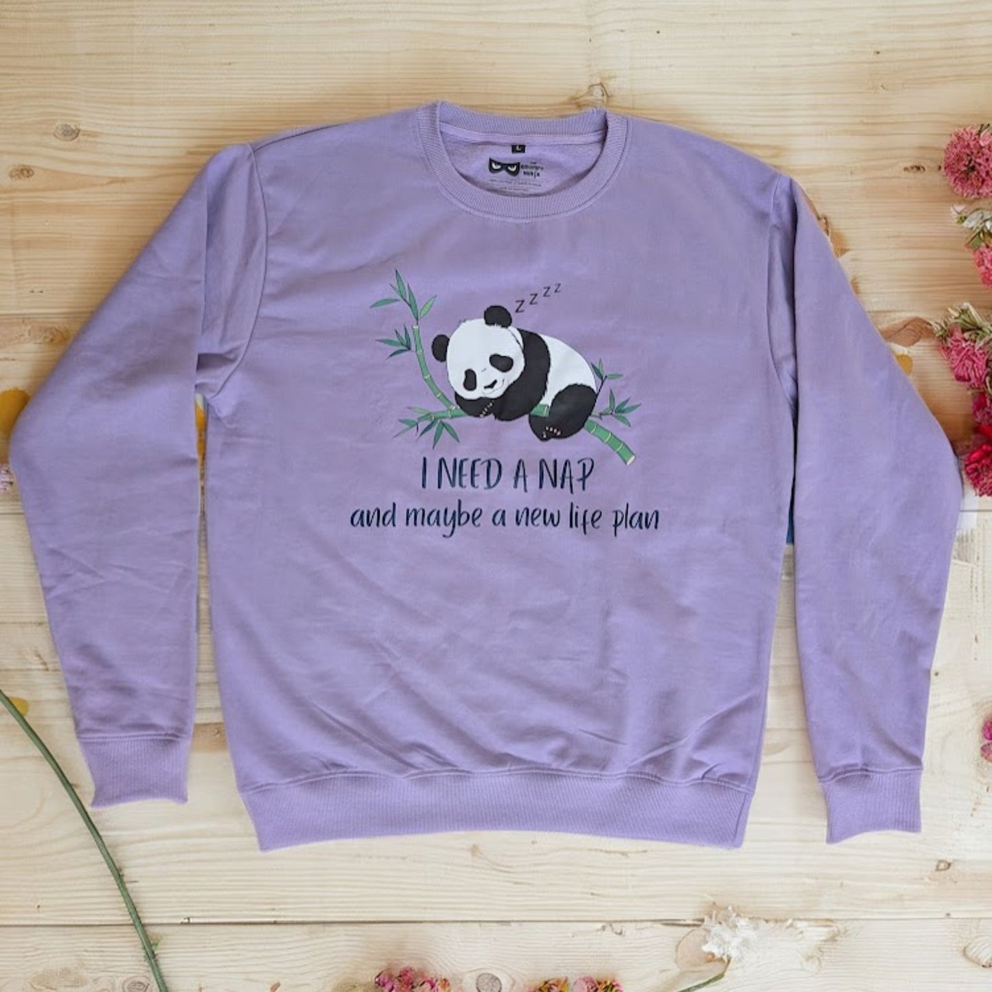 Flat lay of a sarcastic graphic sweatshirt with a cute panda graphic for introverts and nap champions.