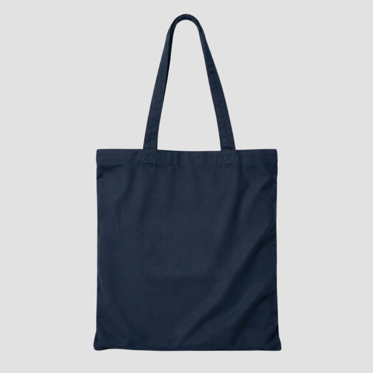 Back view of a plain blue canvas tote bag with zipper closure