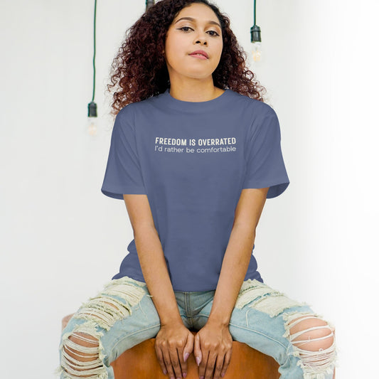 Funny quote t shirt with “Freedom is overrated, I’d rather be comfortable” text in a clean minimalist design