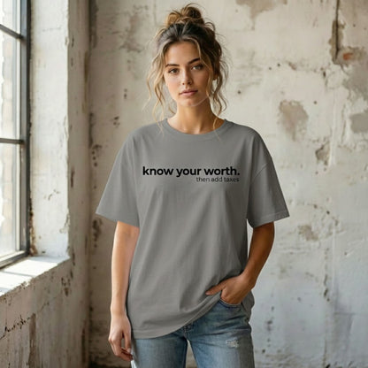 Grey unisex sarcastic graphic tee with the phrase “know your worth then add taxes,” relaxed casual t-shirt style.