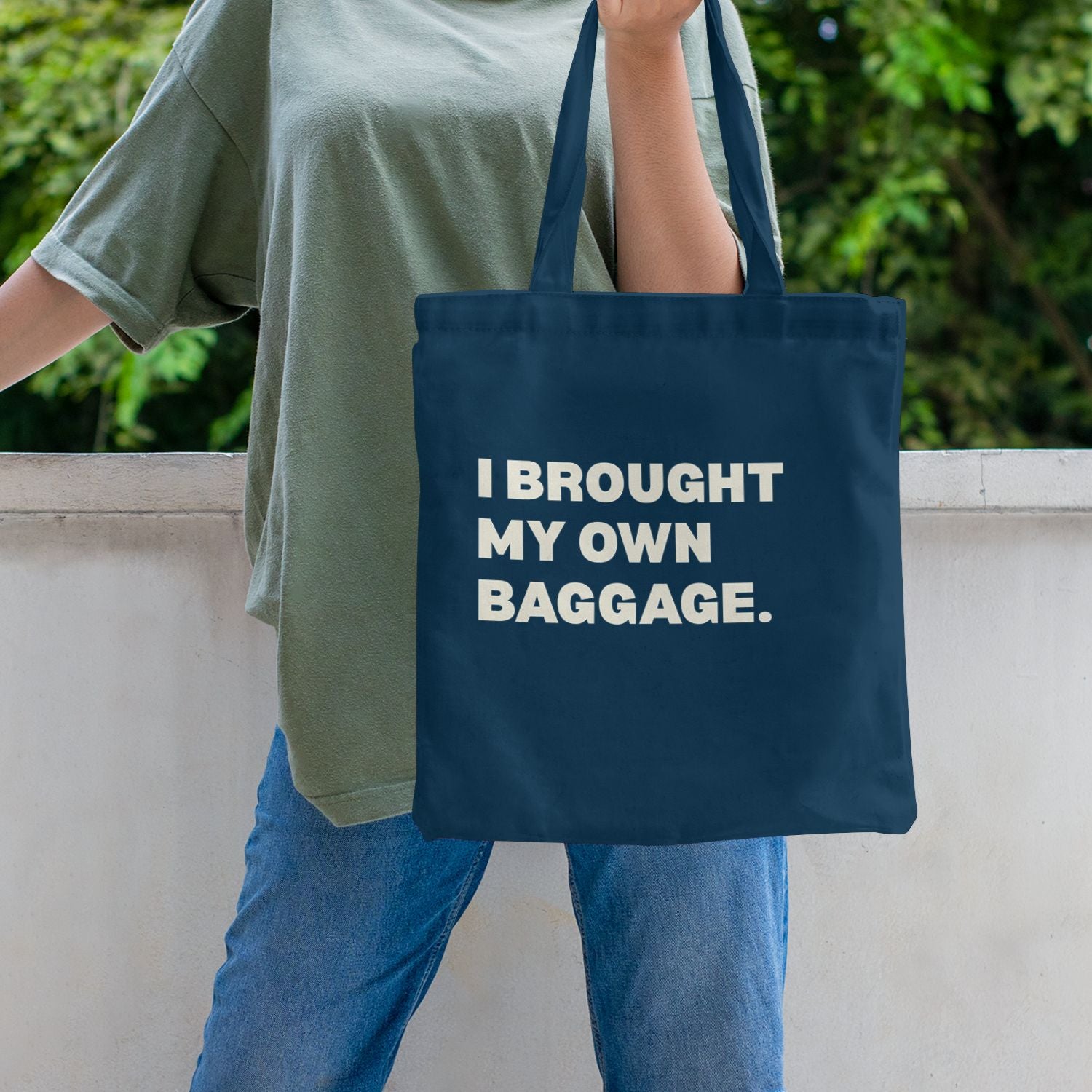 blue canvas tote bag with bold I Brought My Own Baggage statement print
