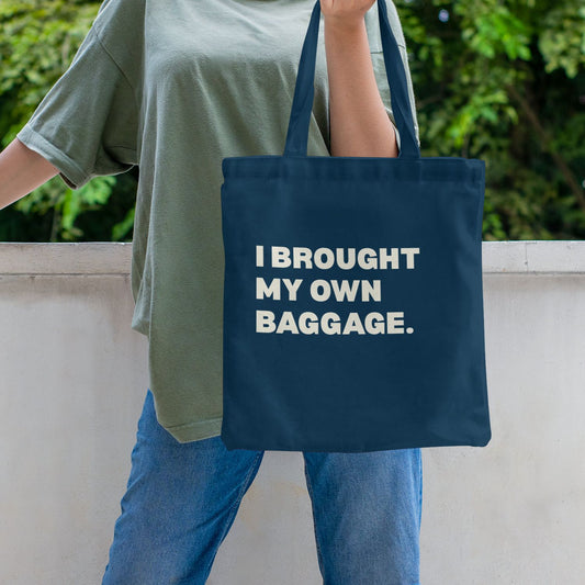 blue canvas tote bag with bold I Brought My Own Baggage statement print