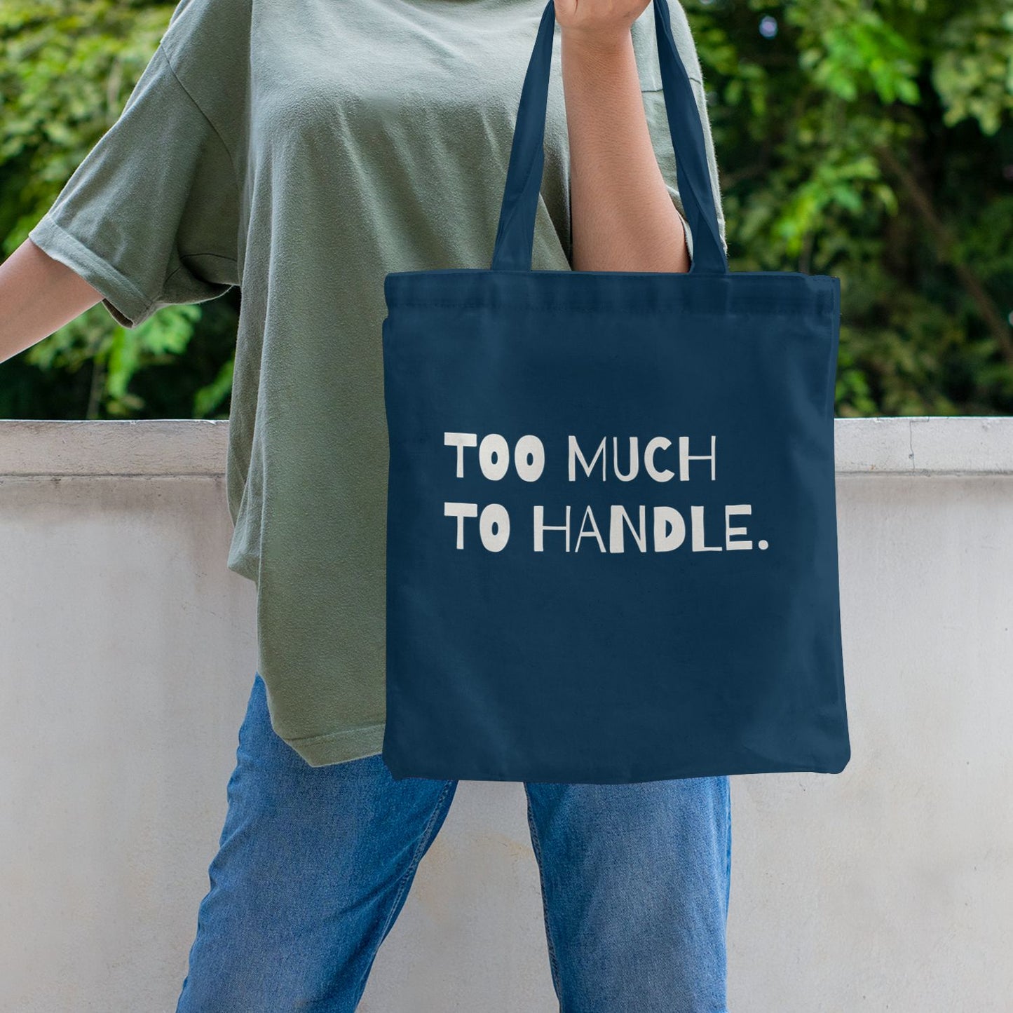 Navy blue canvas tote bag with “Too Much to Handle” statement print